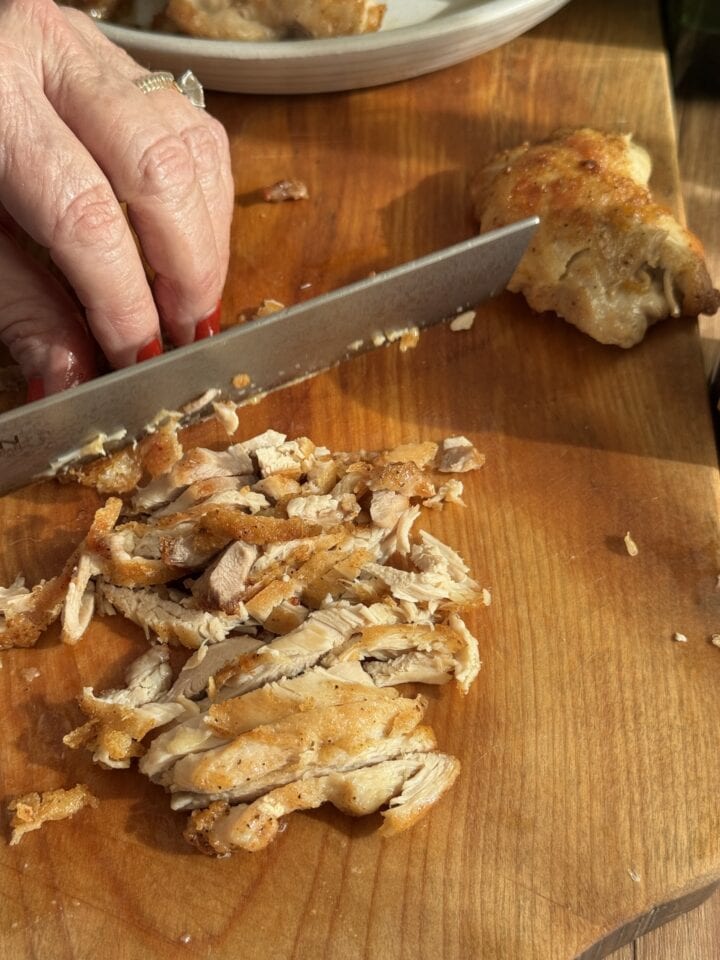 cut chicken pieces on a wooden cutting board