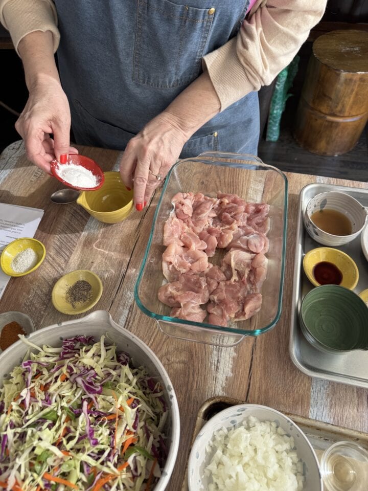 teri combining the dry ingredients to mix in with the chicken thighs