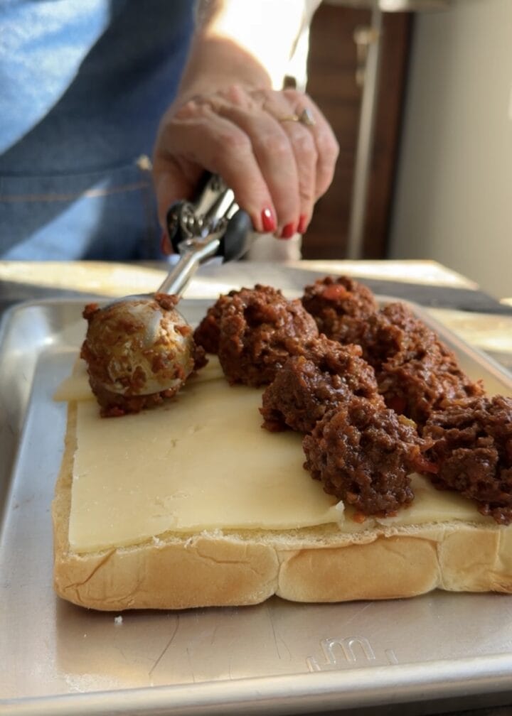 teri scooping sloppy joe mix onto slider buns