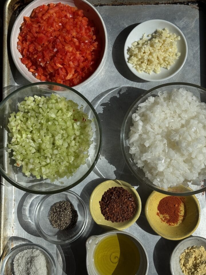 ingredients for sloppy joe sliders in small bowls on a baking sheet