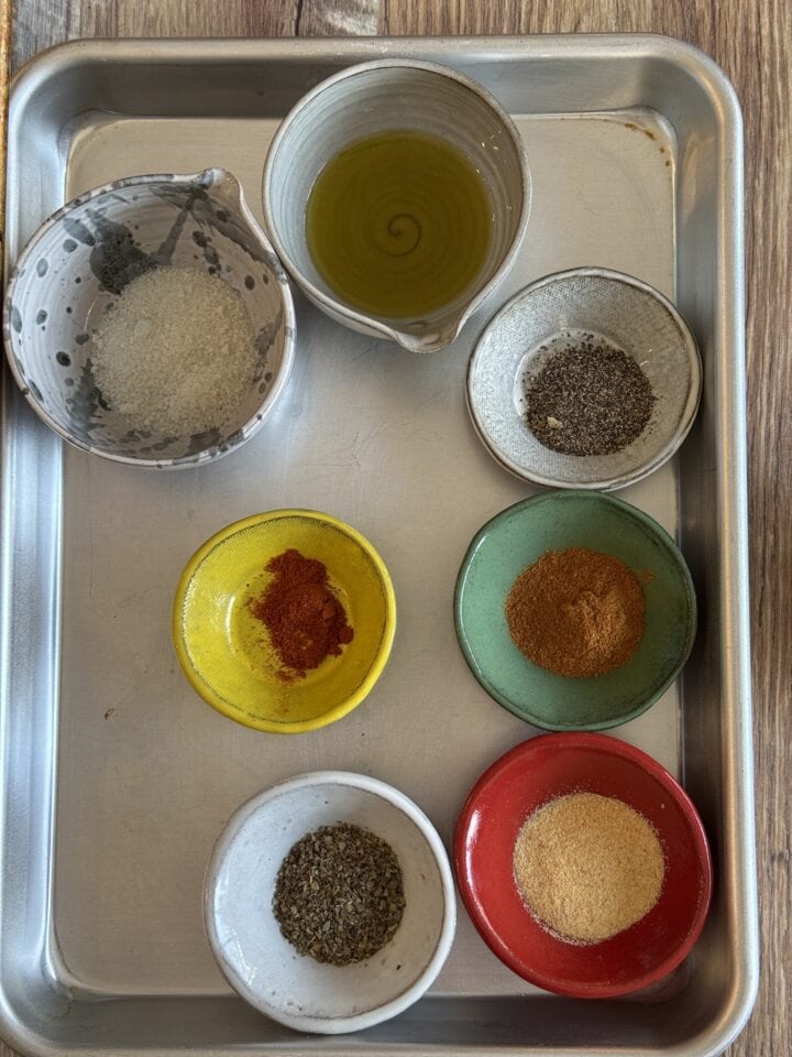 small sheet tray with small bowls of spices and olive oil 