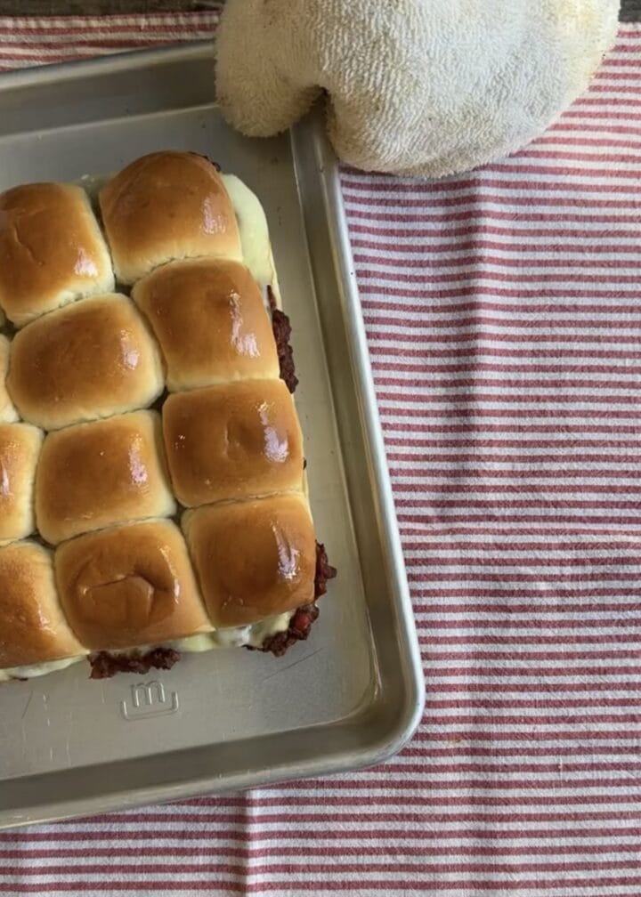 sloppy joe sliders on a baking tray on a red and white striped napkin