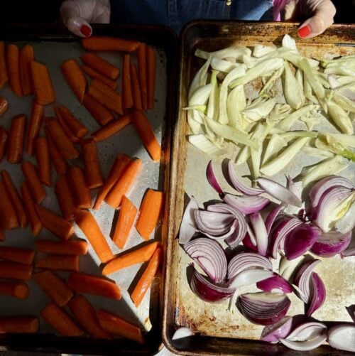 a sheet pan with carrots next to a sheet pan with fennel and red onions