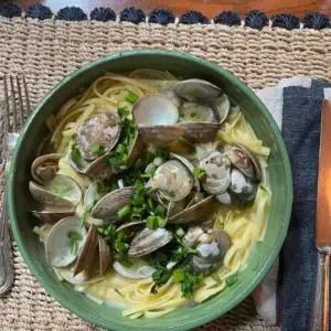 clam pasta in a green bowl