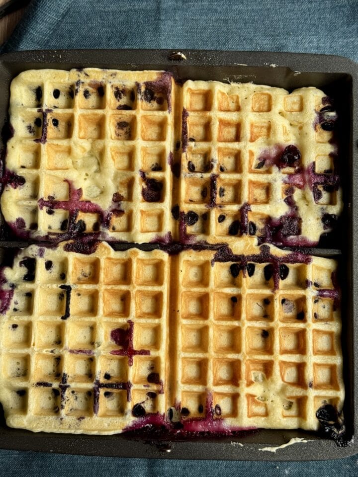 cooked blueberry waffles in a waffle iron