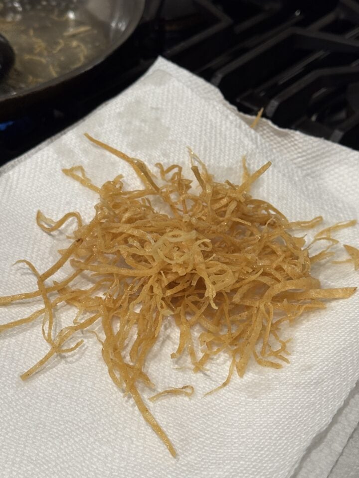 fried tortilla strips on a paper towel