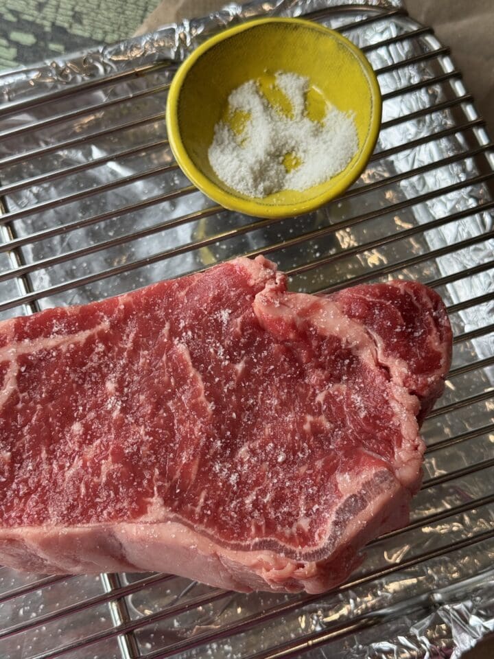 steak with a small bowl of salt next to it