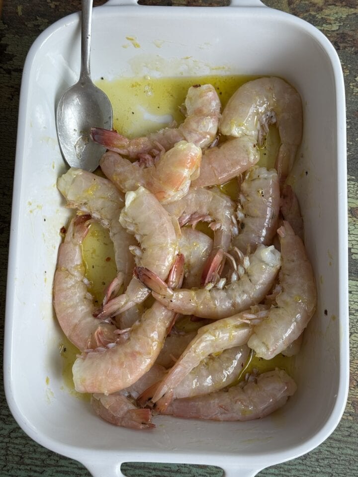 marinated shrimp in a white baking dish