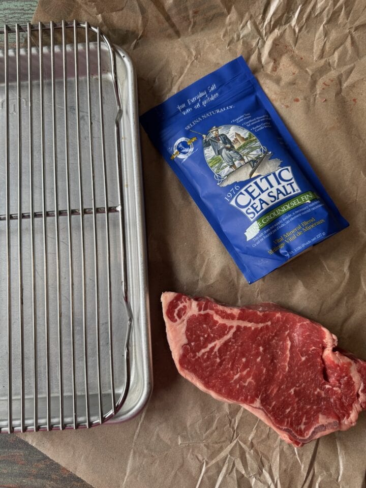 steak, celtic sea salt, and a wire rack on a sheet tray