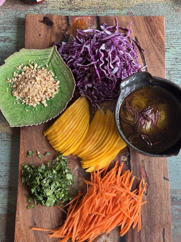 ingredients for a sweet and sour shrimp lettuce wrap on a wooden cutting board