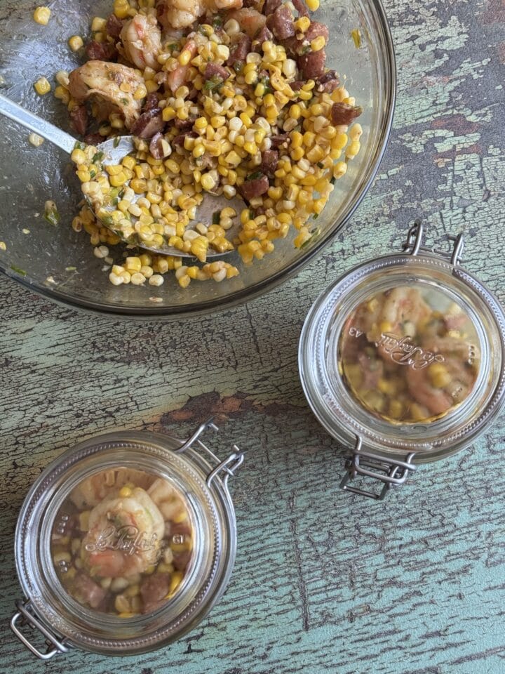 corn and shrimp and chorizo in two small glass jars