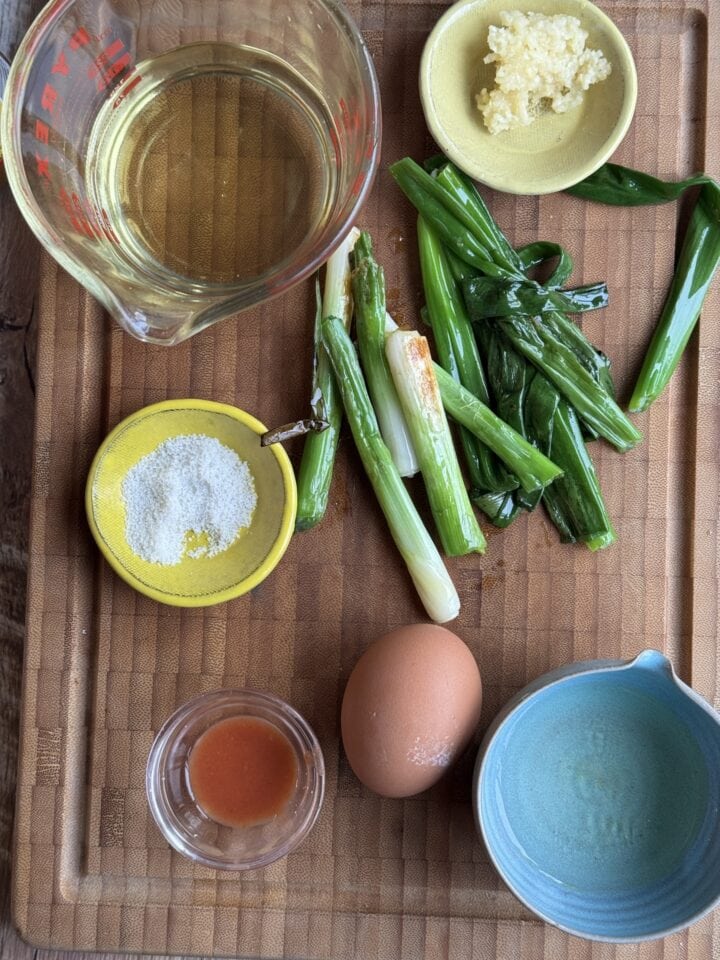 charred scallion dressing ingredients on a wooden cutting board