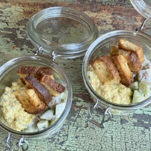 egg salad and cucumber salad mini meal in two glass jars