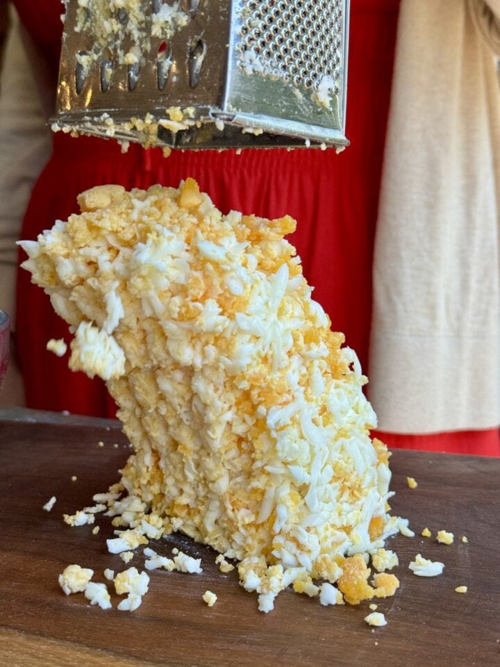 grated eggs on a wooden cutting board