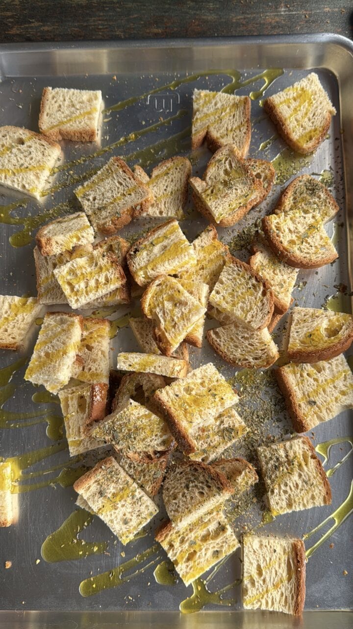cubed bread with oil and spices on it