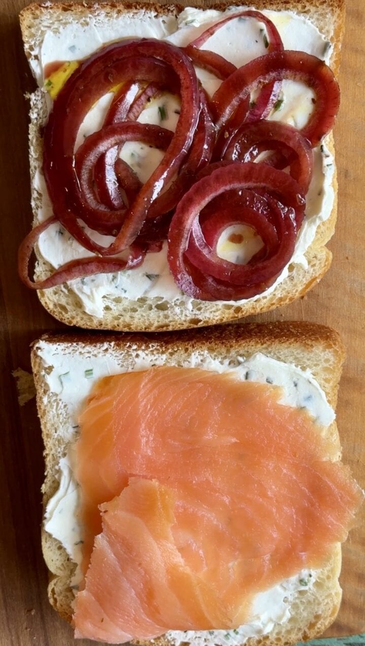 marinated onions and smoked salmon on an open face sandwich