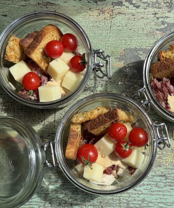 two glass jars with grinder salad in them