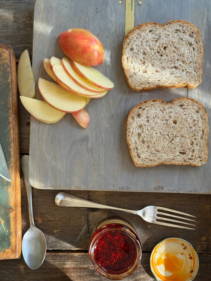 ingredients for an apple grilled cheese on a cutting board