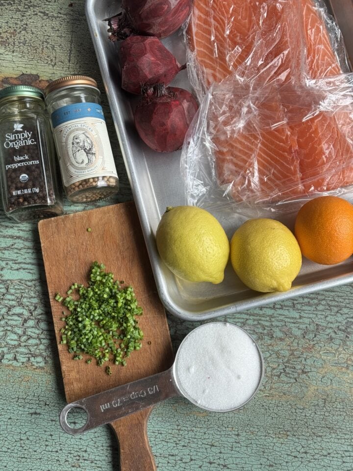 ingredients for salt cured salmon on a baking sheet