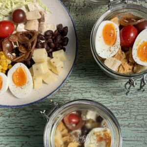 salad in two jars and on a small plate
