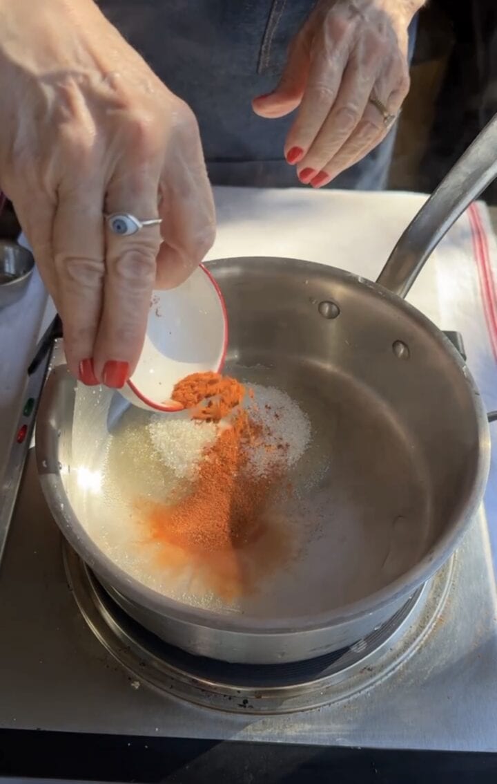 adding sugar and cayenne to pot