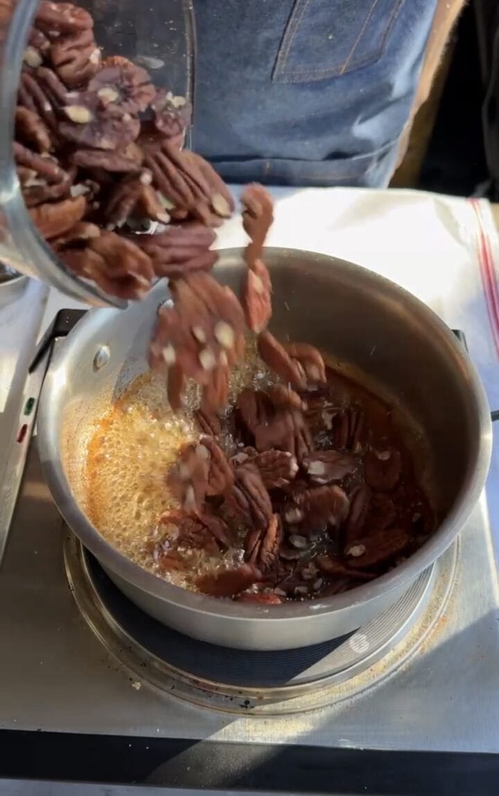 adding pecans to sugar liquid