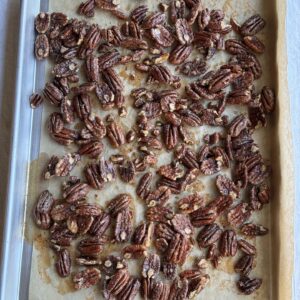 candied pecans on a baking sheet