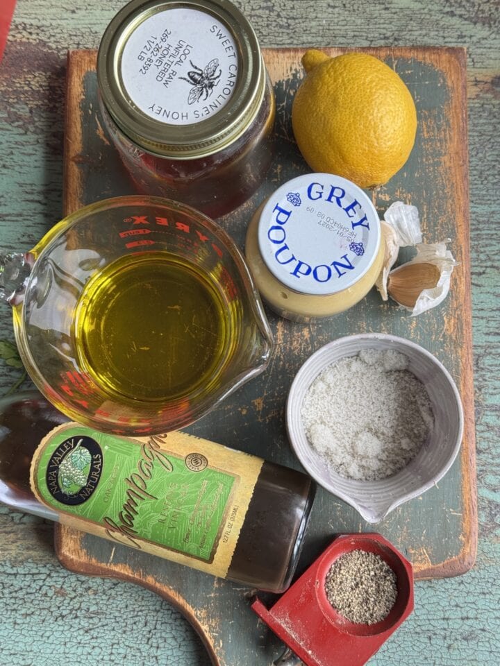 ingredients for the dressing on a wooden cutting board in small bowls