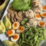 soy marinated eggs with poached shrimp salad on a platter