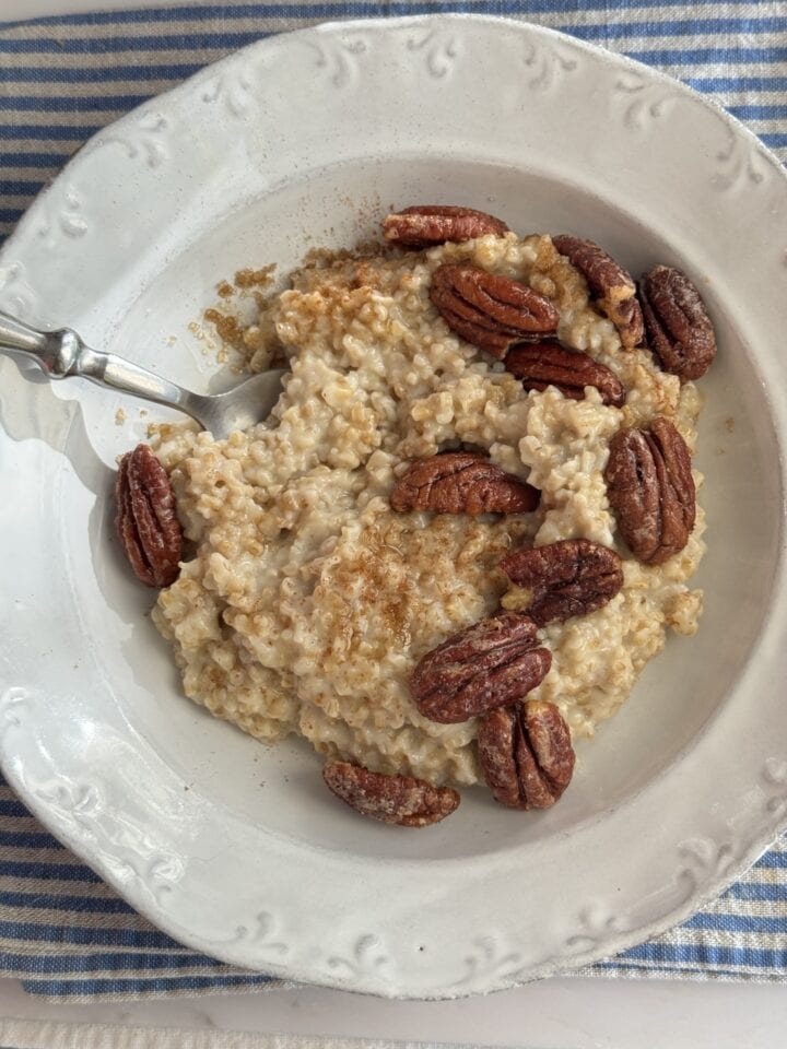 bowl of oatmeal topped with candied pecans