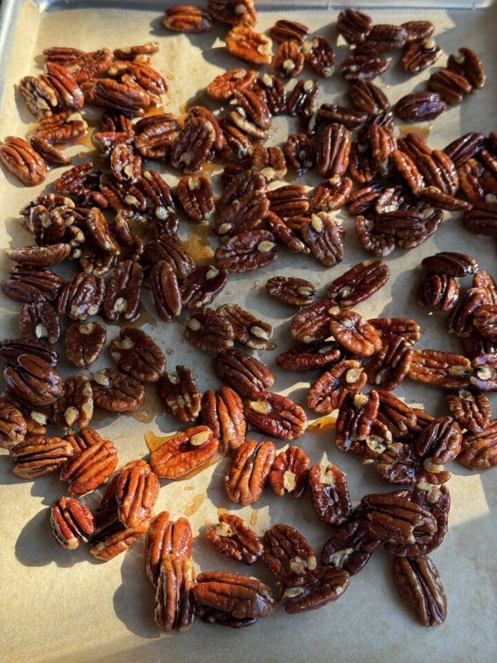 sugar coated pecans on baking sheet