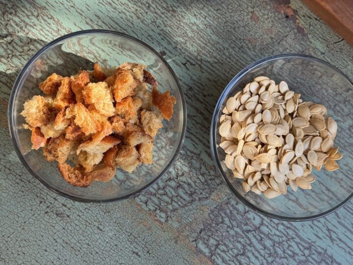 a bowl of croutons and a bowl of pumpkin seeds